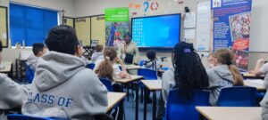Mrs. McGhie-Belgrave MBE talks to children at Corpus Christi RC Primary School