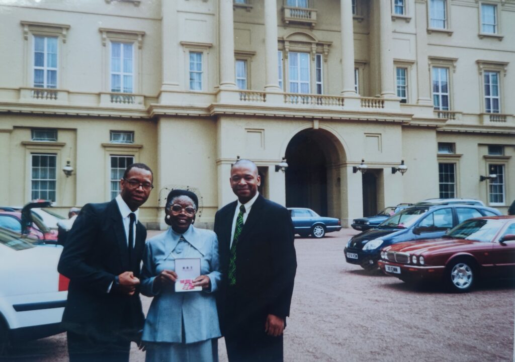 Recieving her MBE at Buckingham Palace with her sons